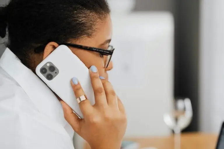 Black woman calling telephone number.